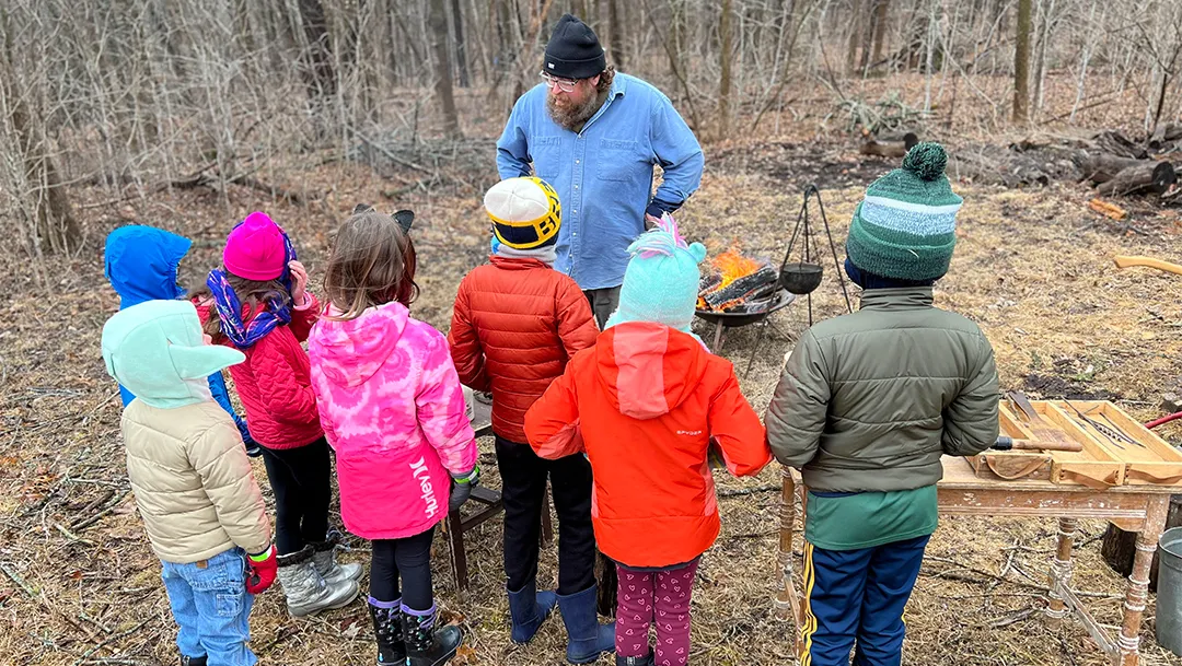 Group of kids learning about how to make maple syrup