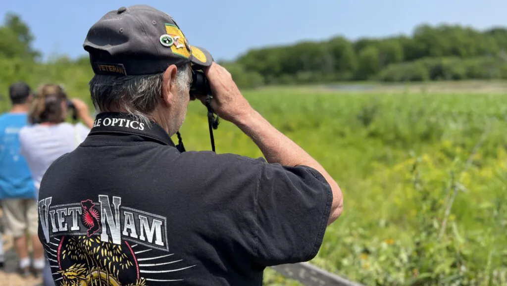 veteran looking at nature through binoculars